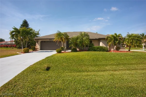 a front view of house with yard and green space