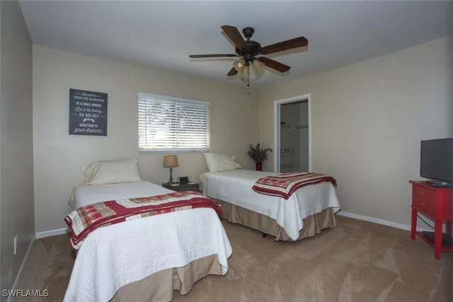 a bedroom with two beds and a chandelier