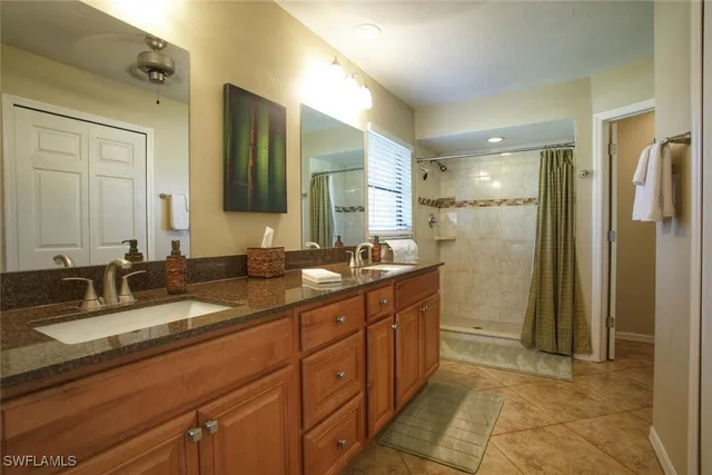 a bathroom with a double vanity sink and a mirror