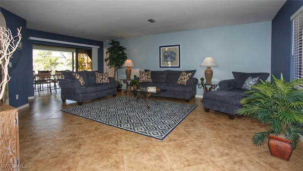 a living room with furniture rug and a large window