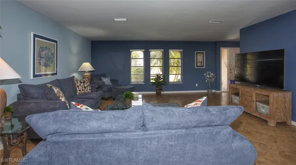a living room with furniture and a flat screen tv