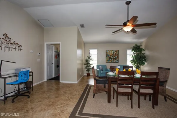 a dining room with a table and chairs