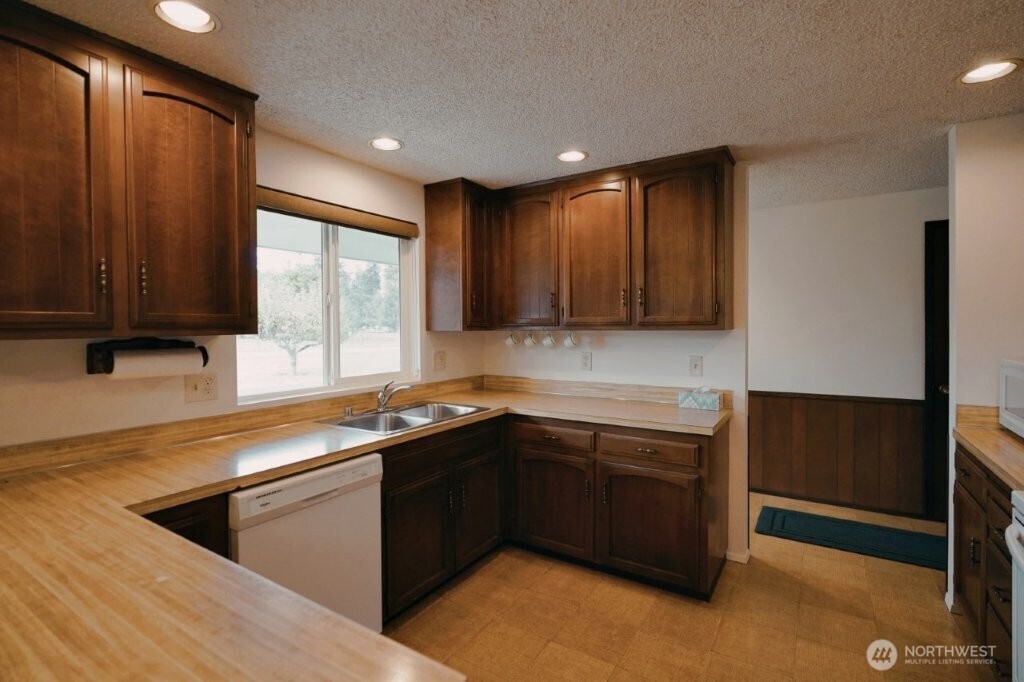 351 Vautier Road Sequim, WA 98382 - Photo 8 of 40 a kitchen with a sink stove and cabinets