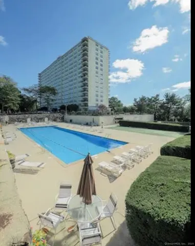 a view of a swimming pool with lounge chair