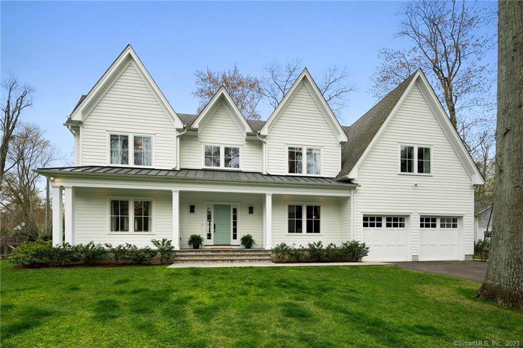 a front view of a house and a garden