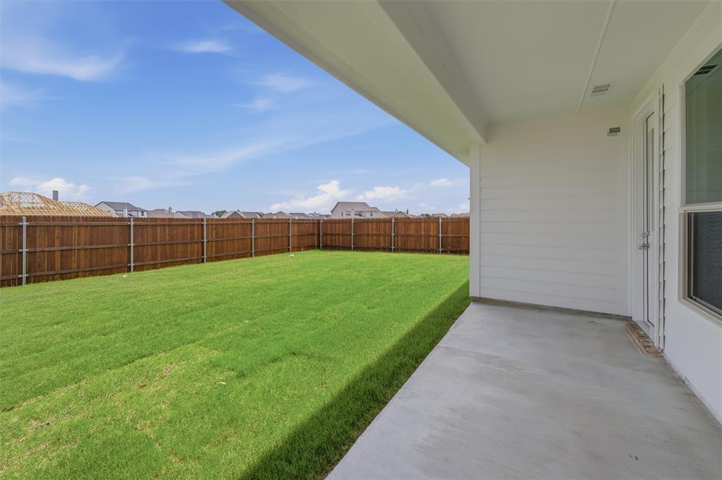 1209 Colca Drive Springtown, TX 76082 - Photo 20 of 24 Expansive backyard featuring a manicured lawn, full privacy fencing, and a concrete patio