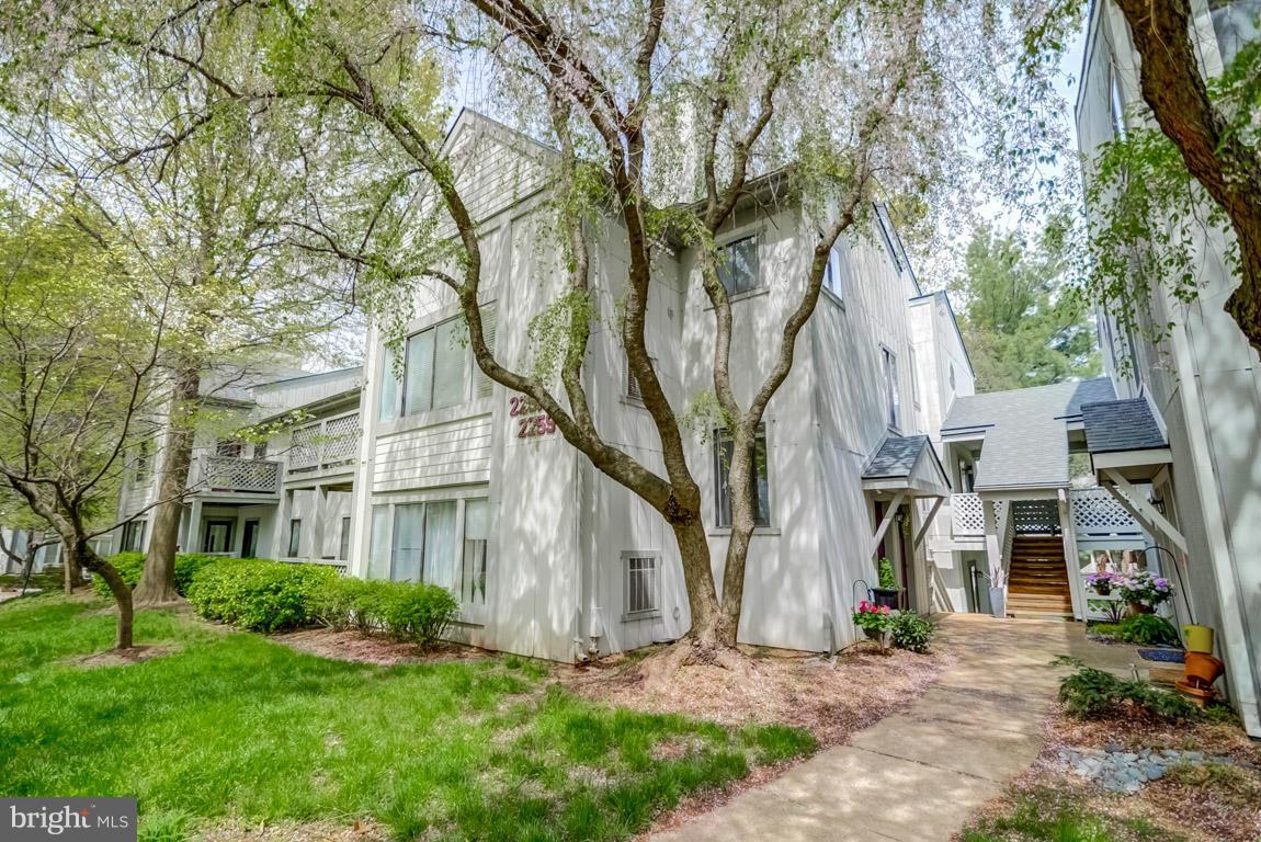 2253 Hunter's Run Drive, Unit 2253 Reston, VA 20191 - Photo 1 of 25 front view of a house with a yard