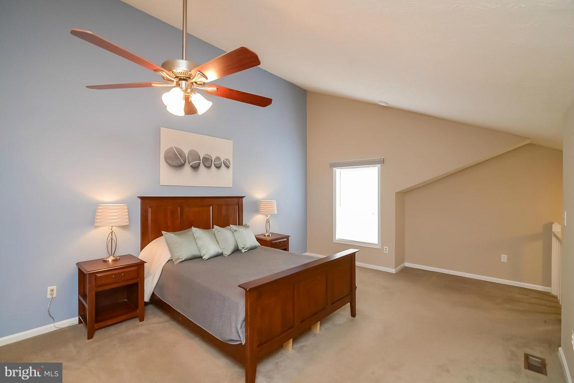2253 Hunter's Run Drive, Unit 2253 Reston, VA 20191 - Photo 13 of 25 a bed room with a bed and a chandelier
