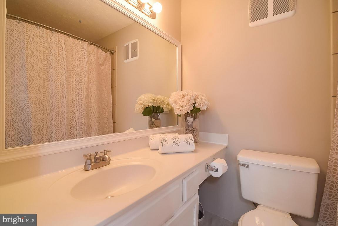 2253 Hunter's Run Drive, Unit 2253 Reston, VA 20191 - Photo 15 of 25 a bathroom with a toilet sink and mirror