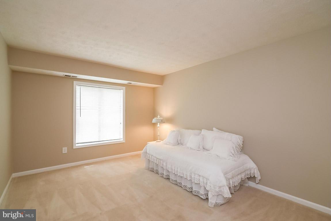 2253 Hunter's Run Drive, Unit 2253 Reston, VA 20191 - Photo 17 of 25 a spacious bedroom with a bed and a window