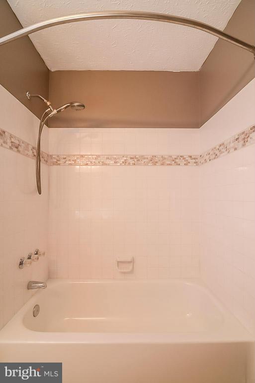 2253 Hunter's Run Drive, Unit 2253 Reston, VA 20191 - Photo 19 of 25 a bathroom with a bathtub and a shower