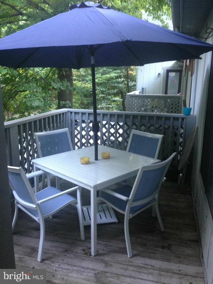 2253 Hunter's Run Drive, Unit 2253 Reston, VA 20191 - Photo 22 of 25 a view of a patio with table and chairs