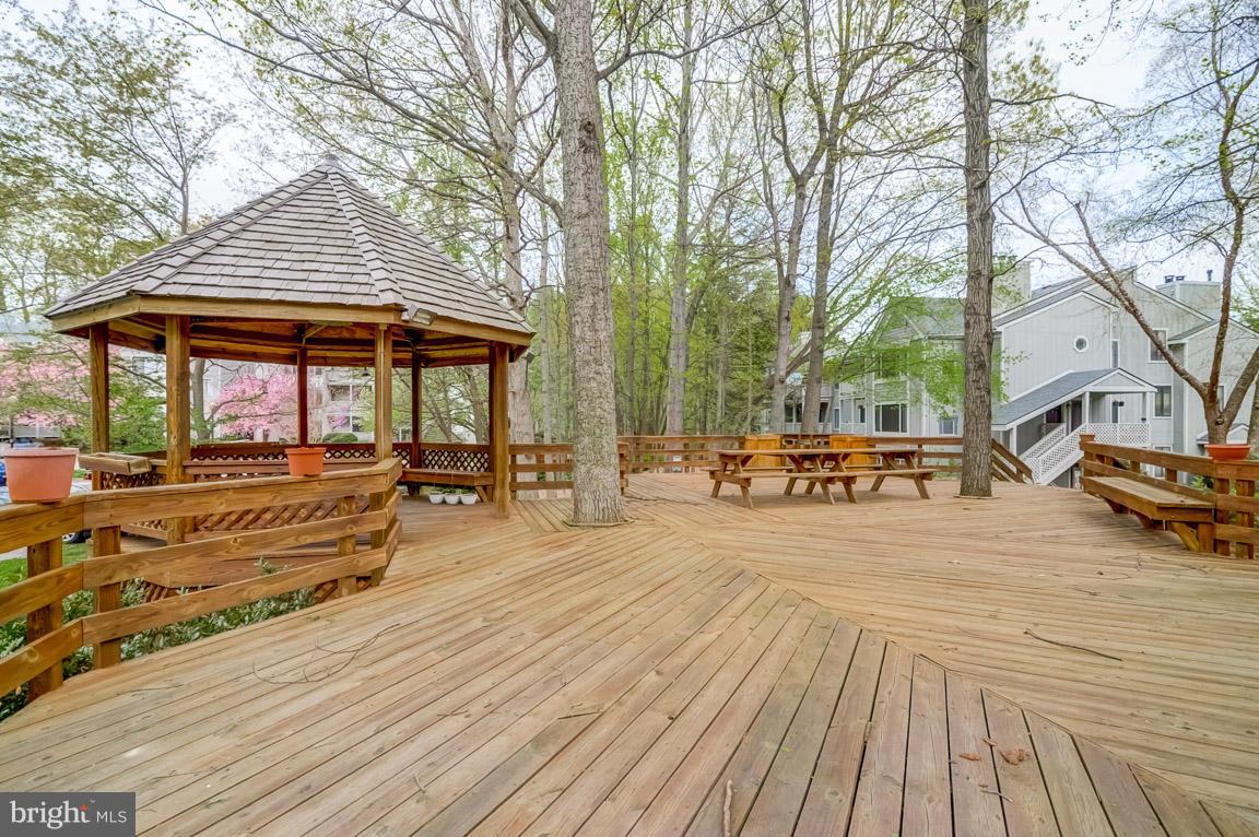 2253 Hunter's Run Drive, Unit 2253 Reston, VA 20191 - Photo 24 of 25 a view of a house with wooden floor and large trees