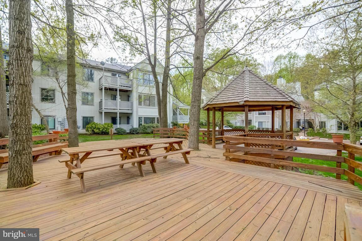 2253 Hunter's Run Drive, Unit 2253 Reston, VA 20191 - Photo 25 of 25 a backyard of a house with wooden floor and outdoor seating