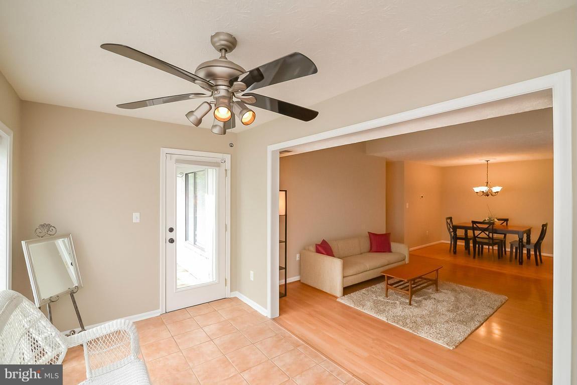 2253 Hunter's Run Drive, Unit 2253 Reston, VA 20191 - Photo 5 of 25 a living room with furniture and a chandelier