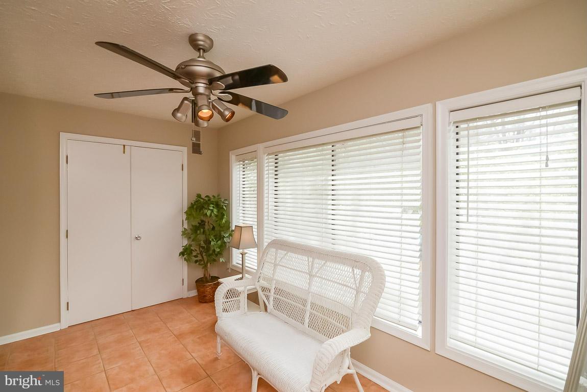2253 Hunter's Run Drive, Unit 2253 Reston, VA 20191 - Photo 6 of 25 a view of a livingroom with furniture and a window