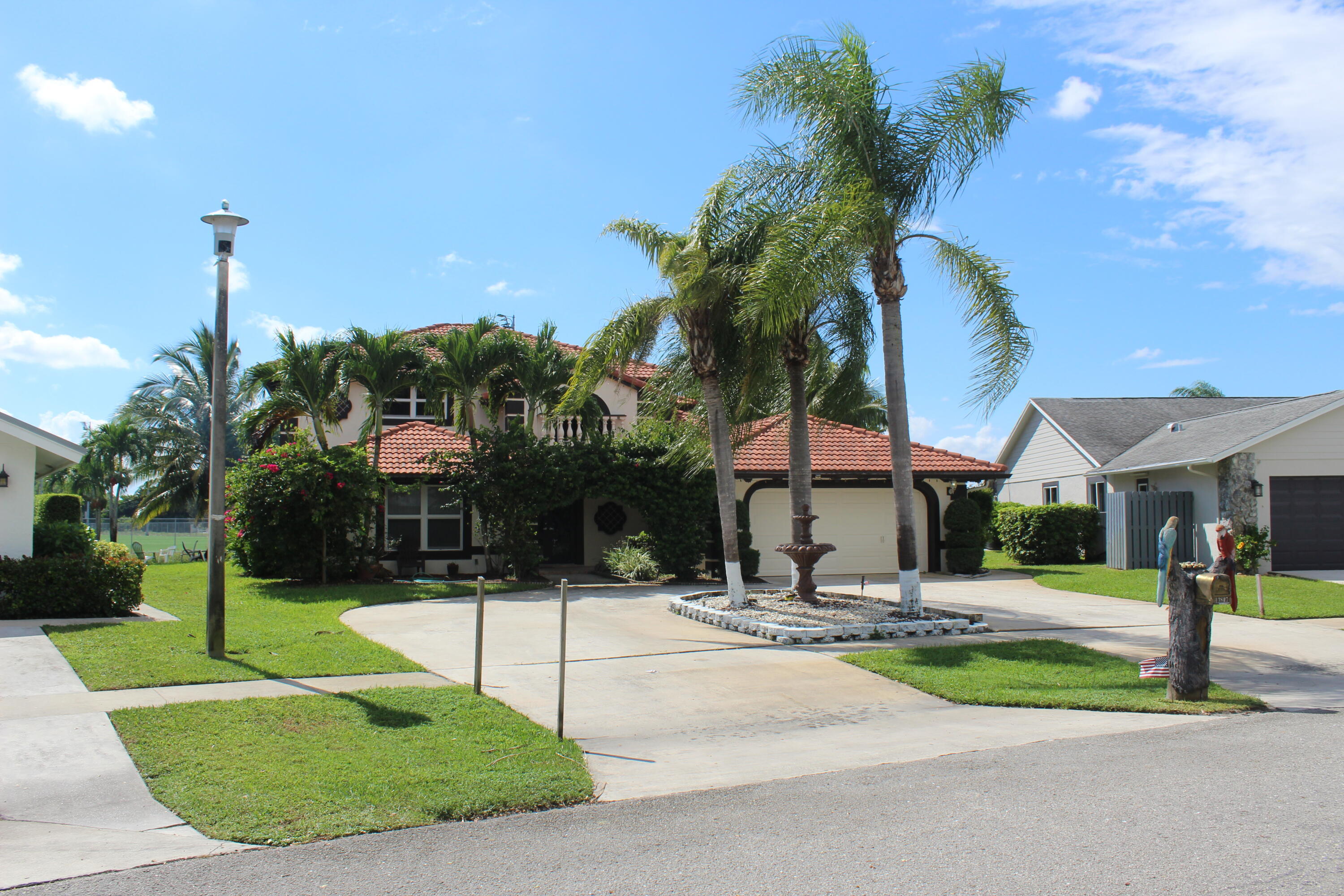 13847 Geranium Place Wellington, FL 33414 - Photo 1 of 50 a outdoor view of a building with garden