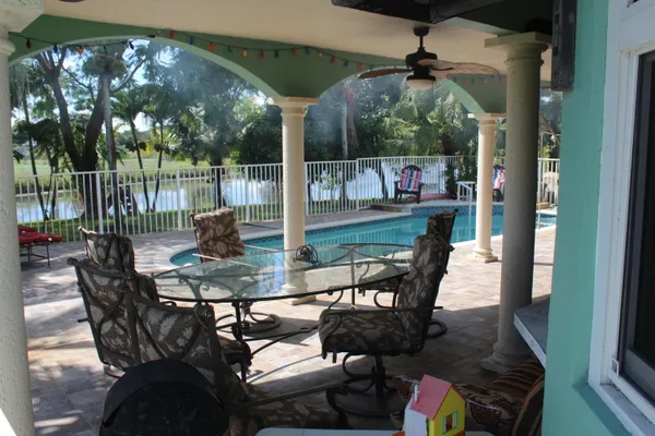 a view of a chairs and table in patio