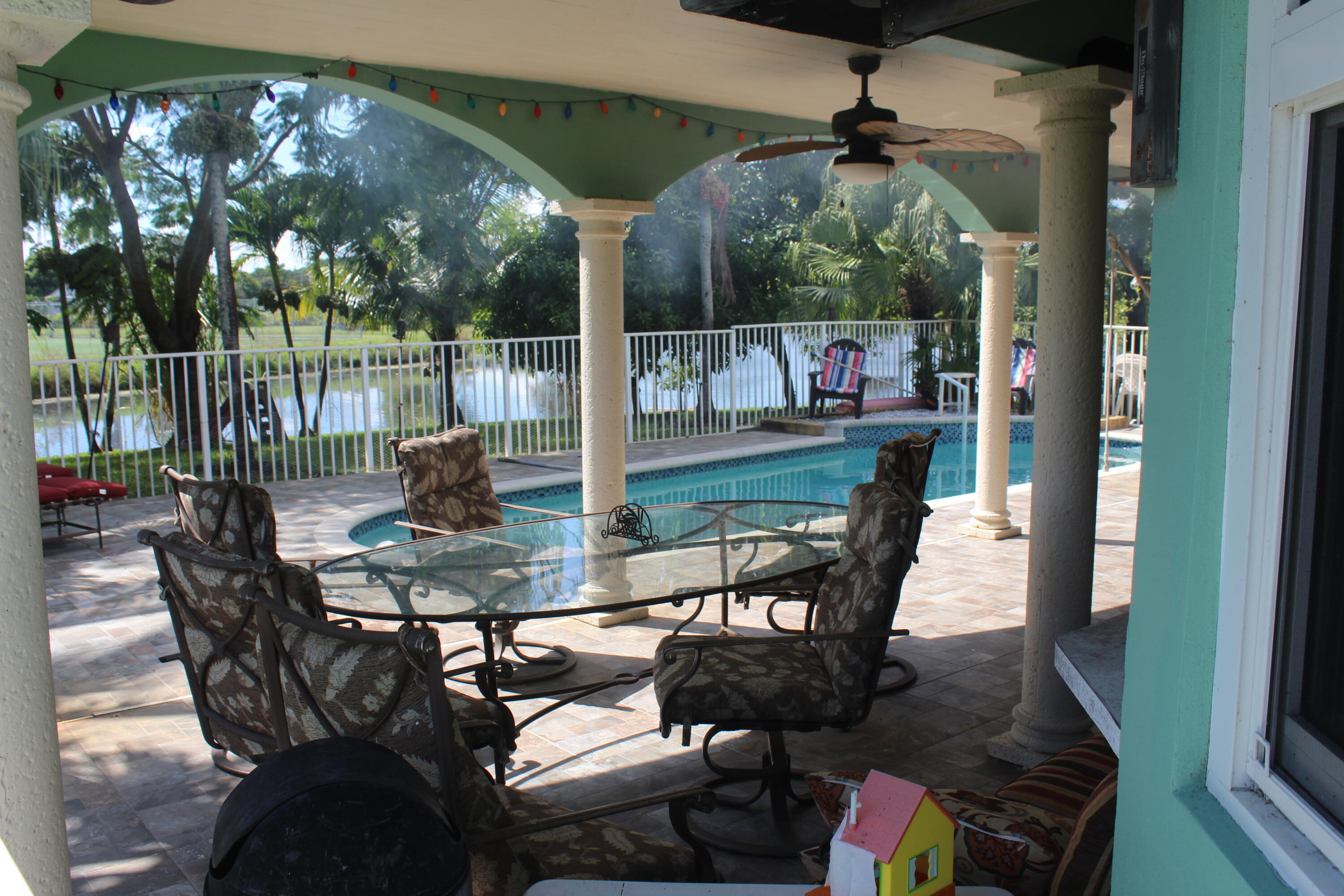 13847 Geranium Place Wellington, FL 33414 - Photo 11 of 50 a view of a chairs and table in patio
