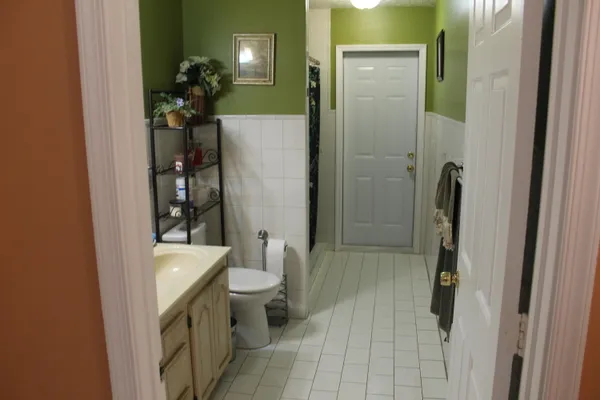 a bathroom with a toilet and a shower