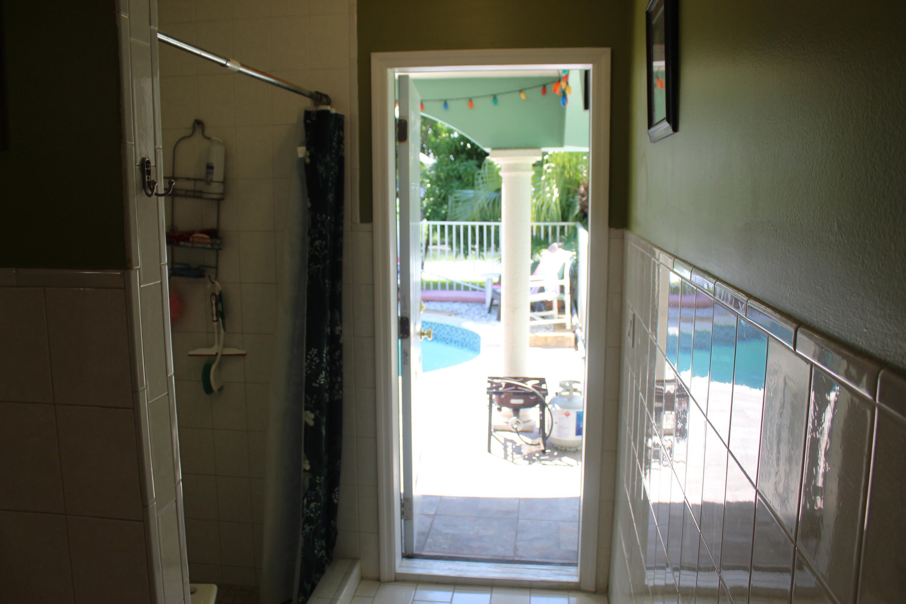 13847 Geranium Place Wellington, FL 33414 - Photo 26 of 50 a bathroom with a glass door and shower