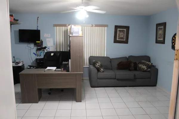 a living room with furniture and a flat screen tv