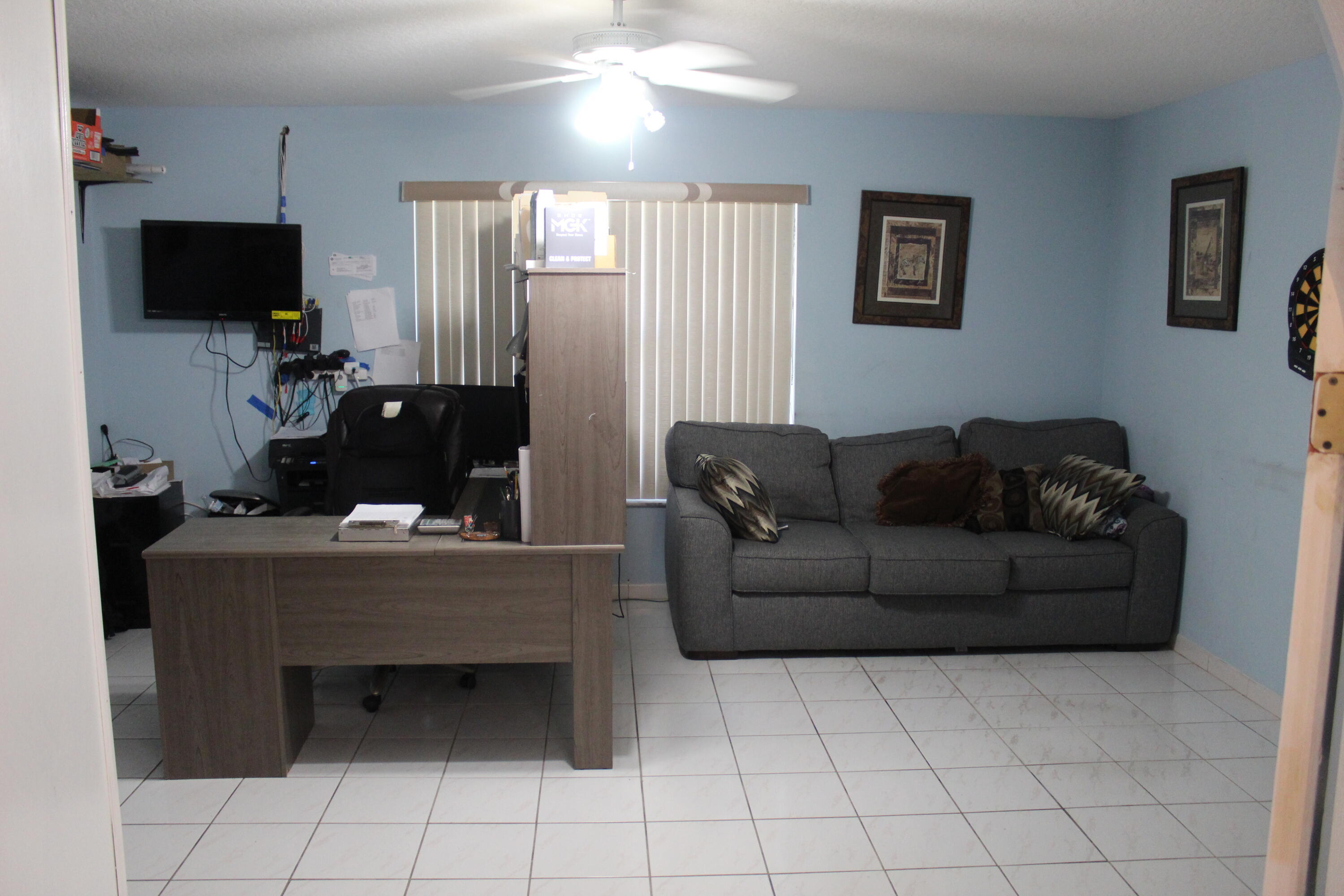 13847 Geranium Place Wellington, FL 33414 - Photo 27 of 50 a living room with furniture and a flat screen tv