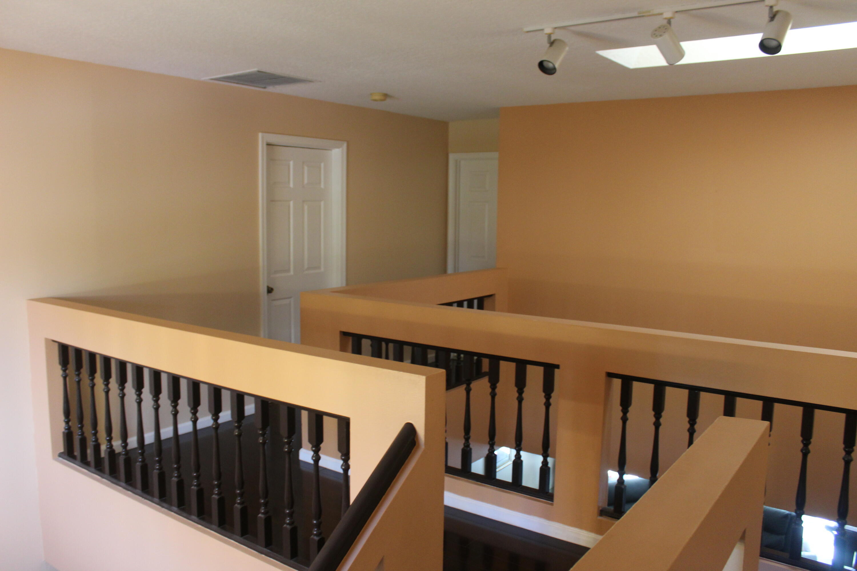 13847 Geranium Place Wellington, FL 33414 - Photo 29 of 50 a view of a hallway with wooden floor and staircase