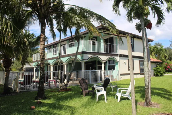a front view of a house with a yard table and chairs