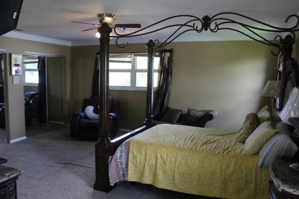 a bedroom with a bed and window