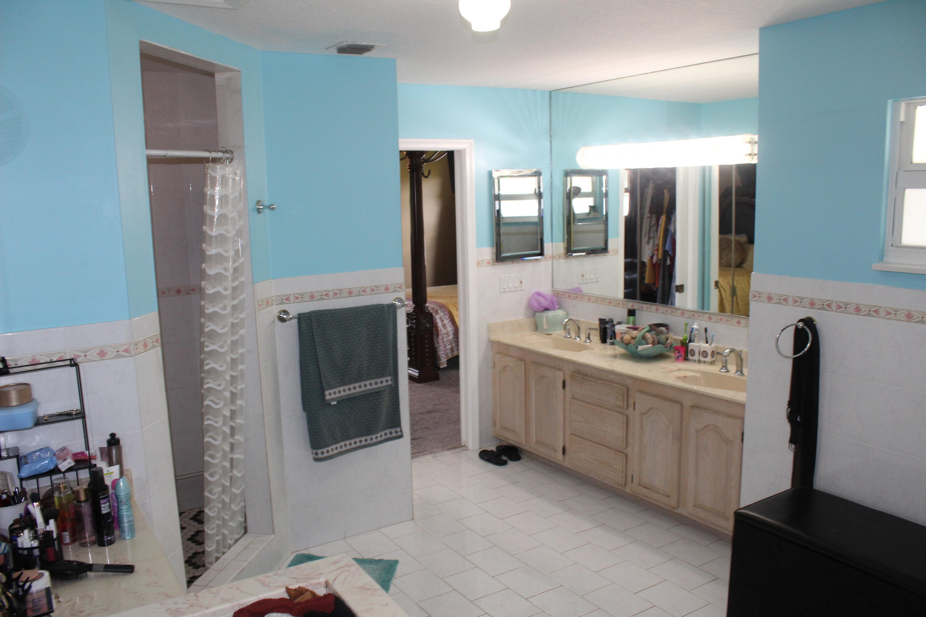 13847 Geranium Place Wellington, FL 33414 - Photo 38 of 50 a bathroom with a double vanity sink a and mirror