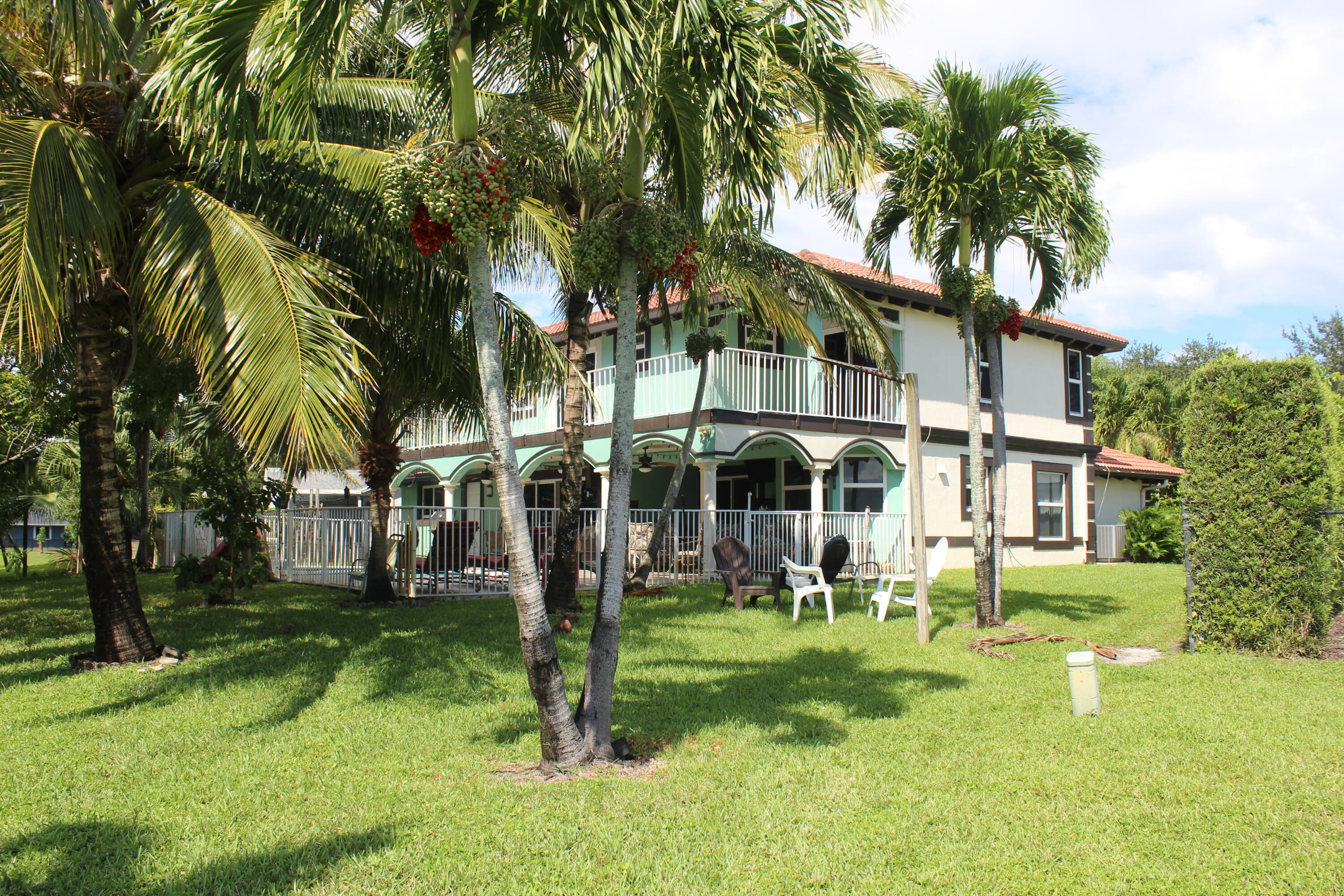 13847 Geranium Place Wellington, FL 33414 - Photo 4 of 50 front view of a house with a yard