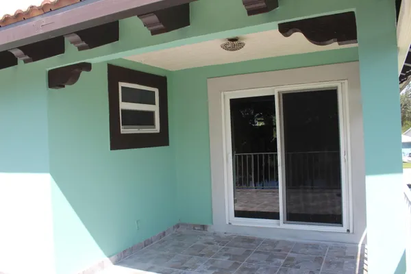a view of a swimming pool with a patio and a yard