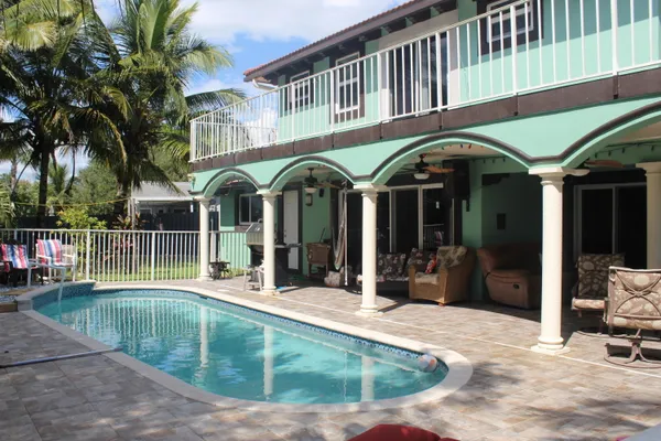 a view of a building with a swimming pool and sitting area