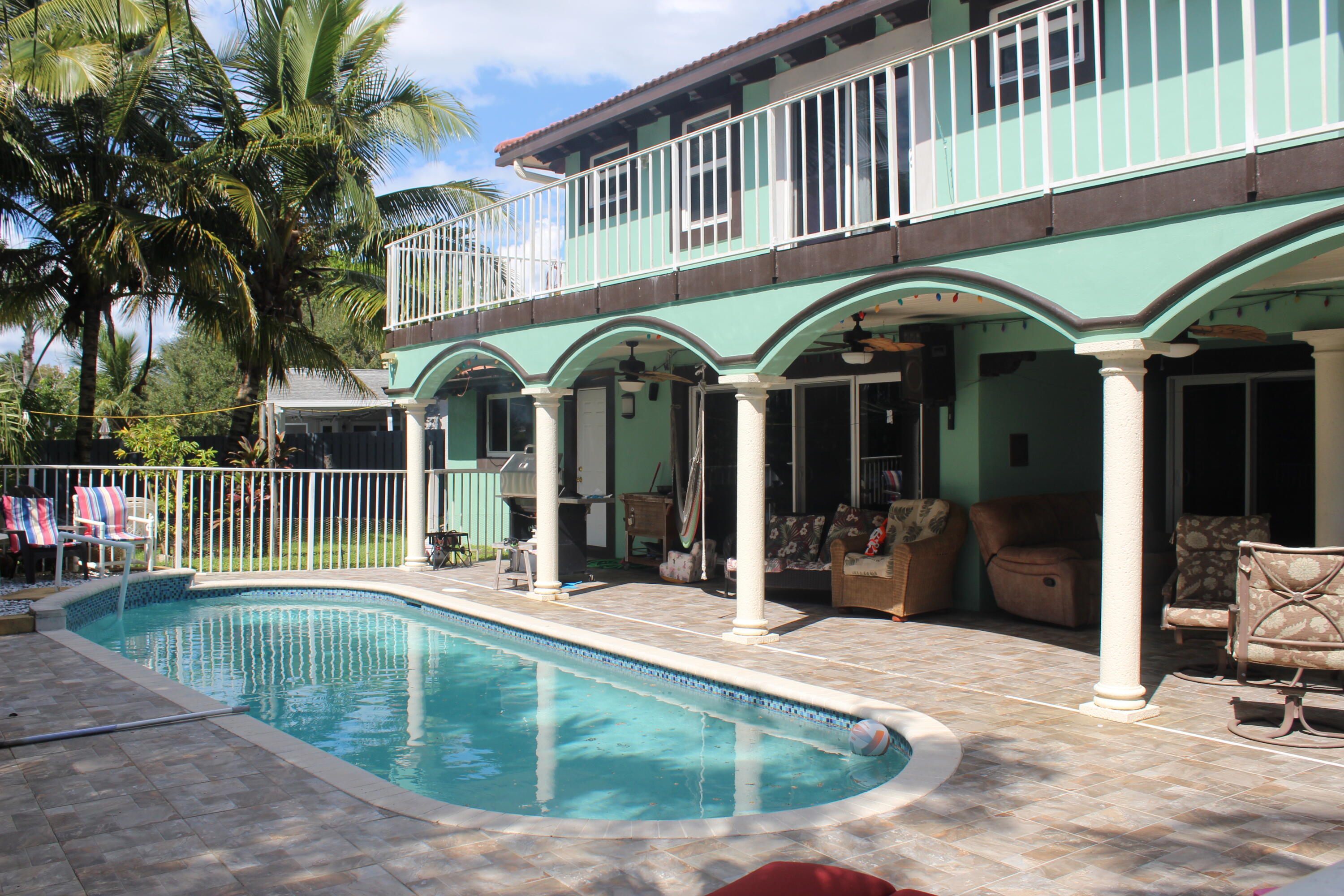 13847 Geranium Place Wellington, FL 33414 - Photo 9 of 50 a view of a building with a swimming pool and sitting area