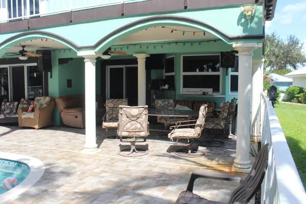 a view of a patio with a table and chairs