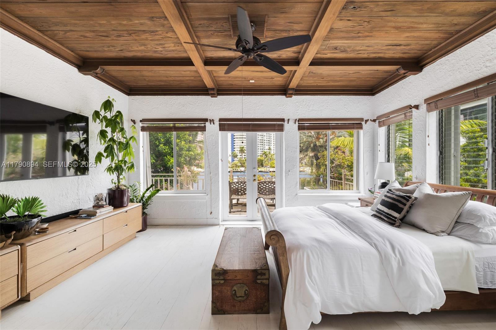 5215 Pine Tree Drive Miami Beach, FL 33140 - Photo 5 of 28 a spacious bedroom with a large bed and windows