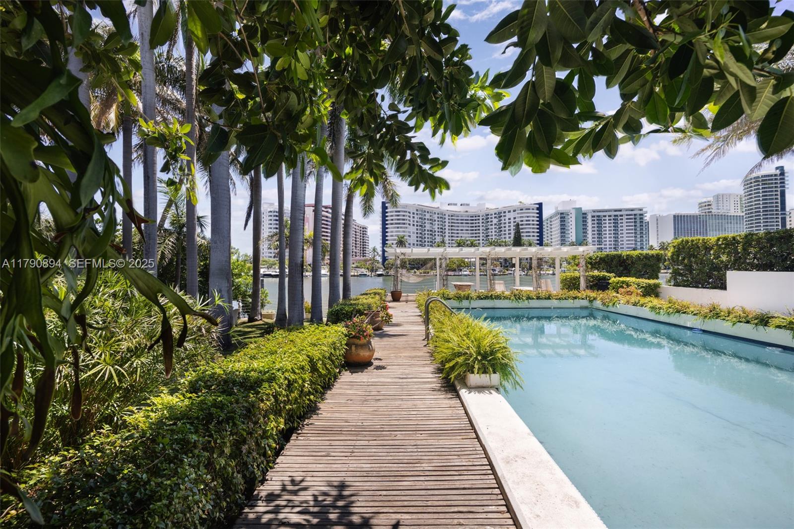 5215 Pine Tree Drive Miami Beach, FL 33140 - Photo 7 of 28 a view of a house with swimming pool and sitting area