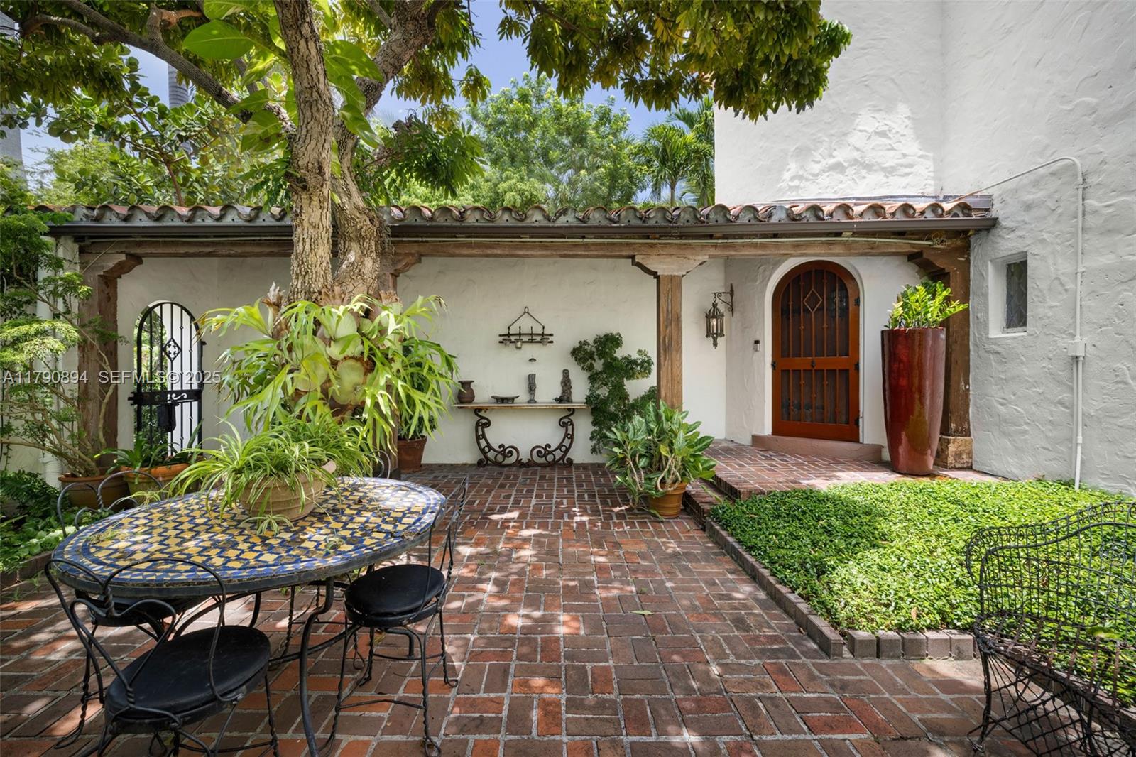 5215 Pine Tree Drive Miami Beach, FL 33140 - Photo 9 of 28 a front view of a house with garden