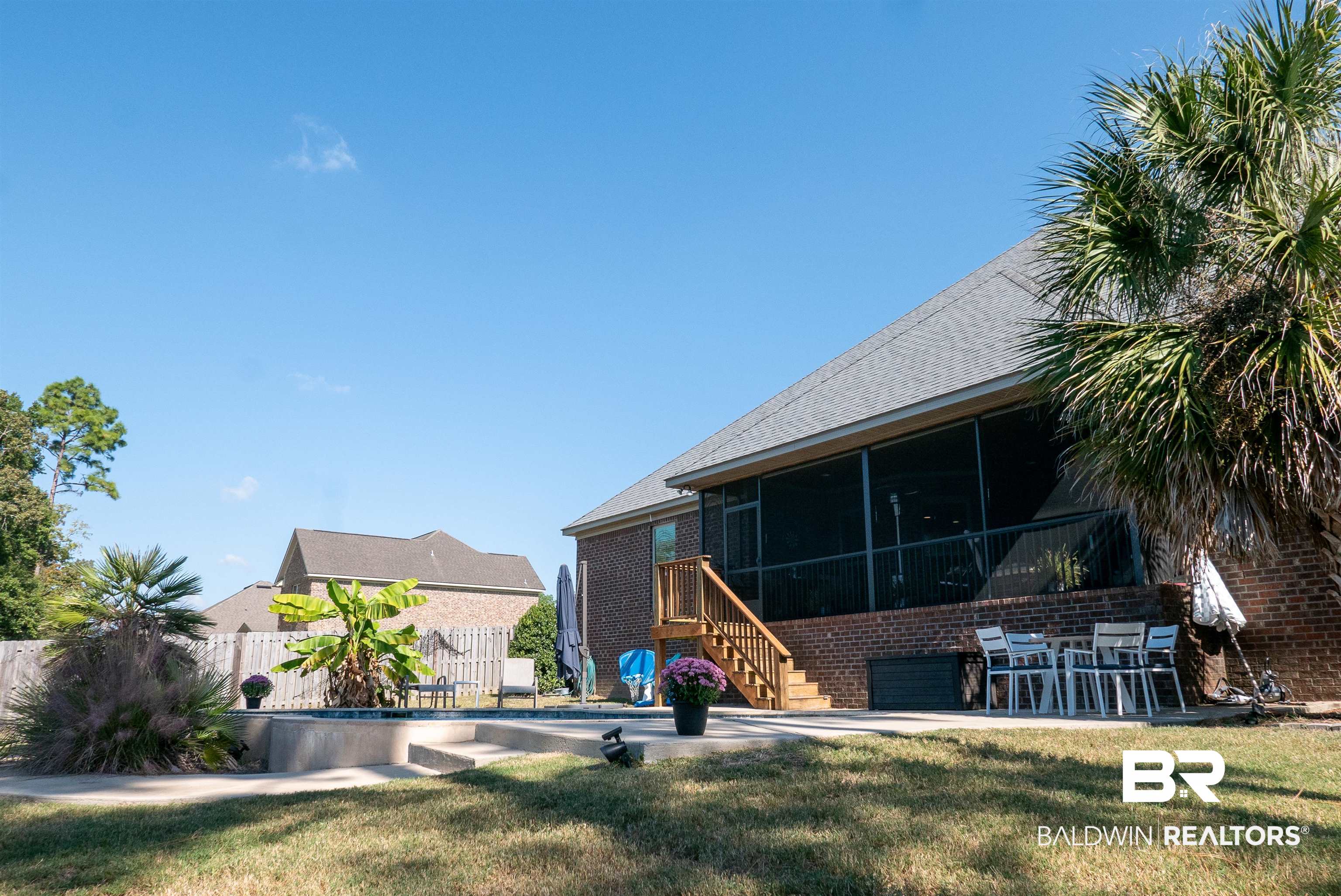 6684 Garrison Drive Daphne, AL 36527 - Photo 24 of 35 Rear view of property featuring a patio, a fenced in pool, a yard, and a sunroom
