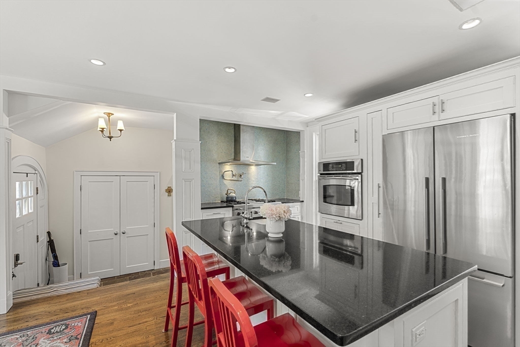 56 Allen Circle Milton, MA 02186 - Photo 11 of 34 a kitchen with stainless steel appliances granite countertop a sink refrigerator and cabinets