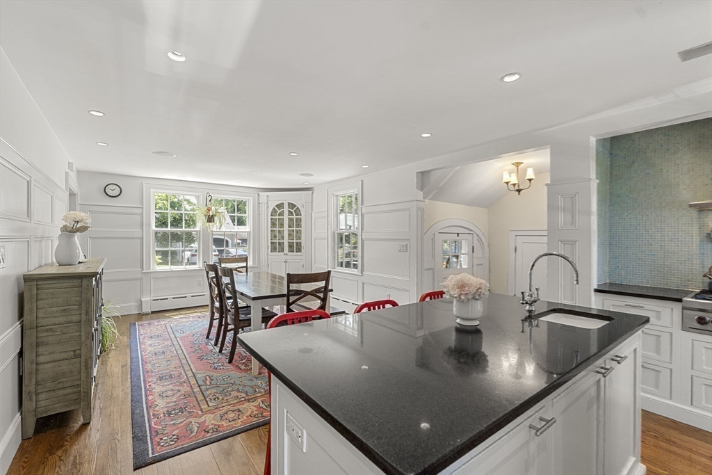 56 Allen Circle Milton, MA 02186 - Photo 12 of 34 a kitchen with stainless steel appliances granite countertop a sink a table and chairs
