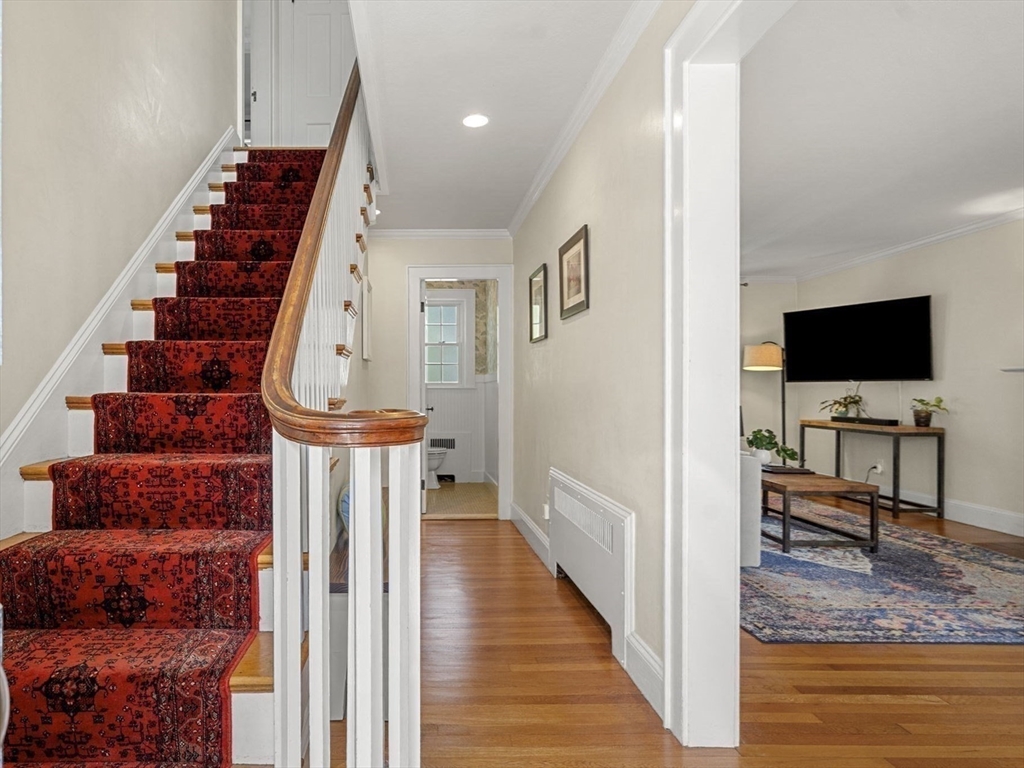 56 Allen Circle Milton, MA 02186 - Photo 20 of 34 a view of a livingroom with wooden floor and stairs