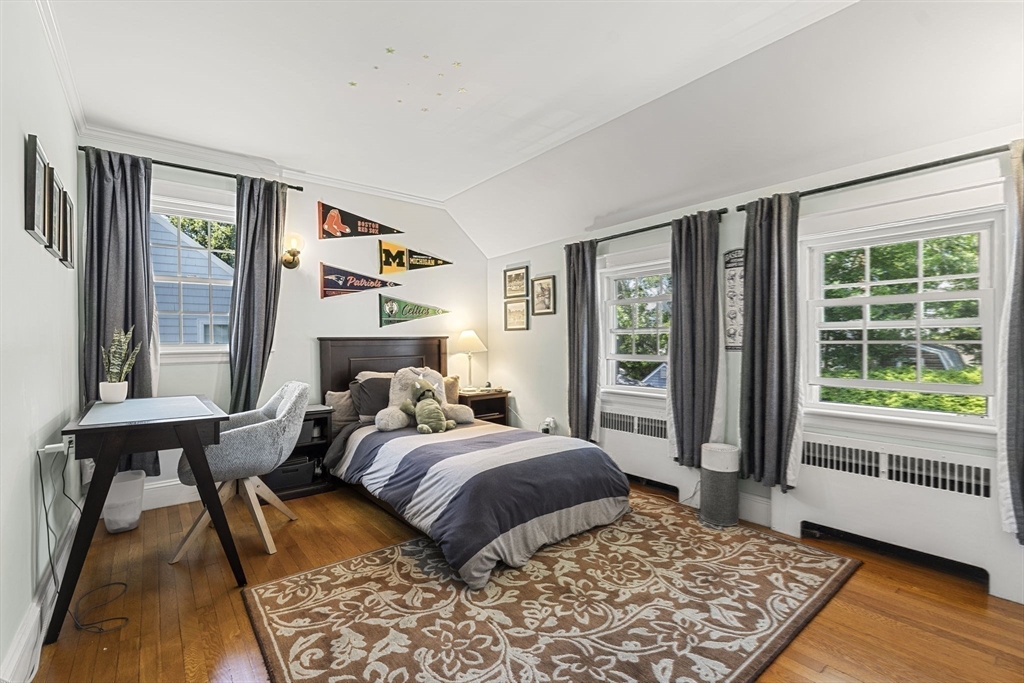 56 Allen Circle Milton, MA 02186 - Photo 21 of 34 a bedroom with a bed and wooden floor