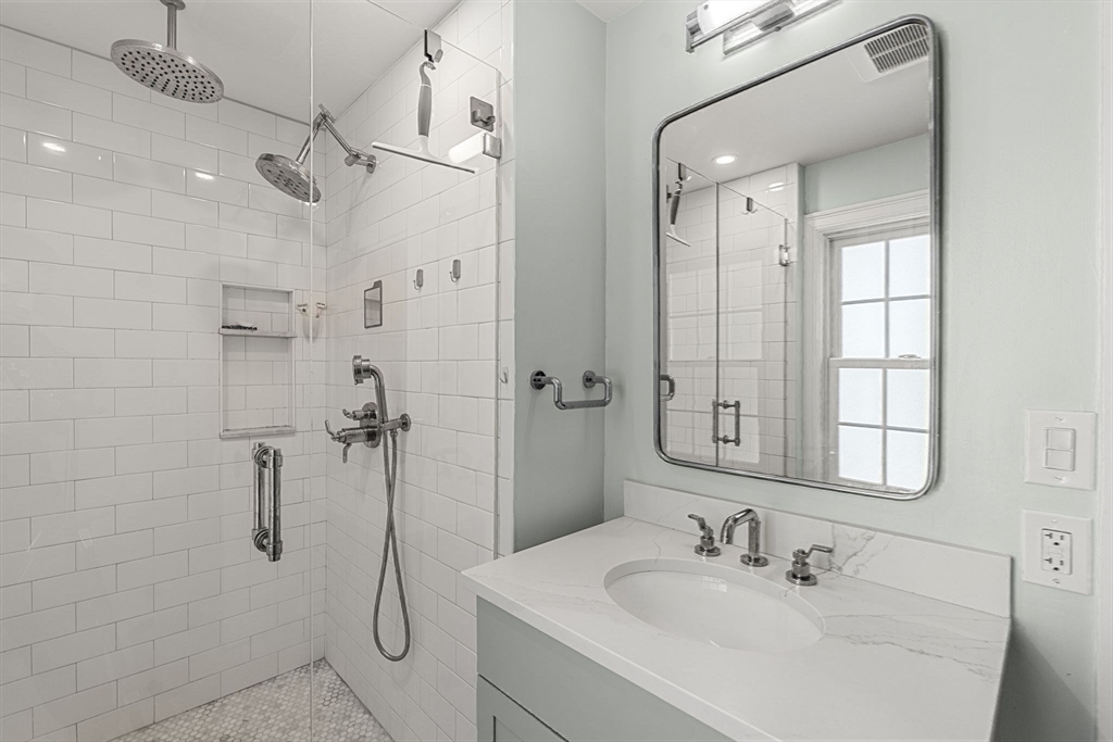 56 Allen Circle Milton, MA 02186 - Photo 24 of 34 a bathroom with a shower sink and mirror