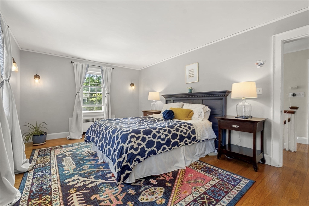 56 Allen Circle Milton, MA 02186 - Photo 25 of 34 a bedroom with a bed and wooden floor