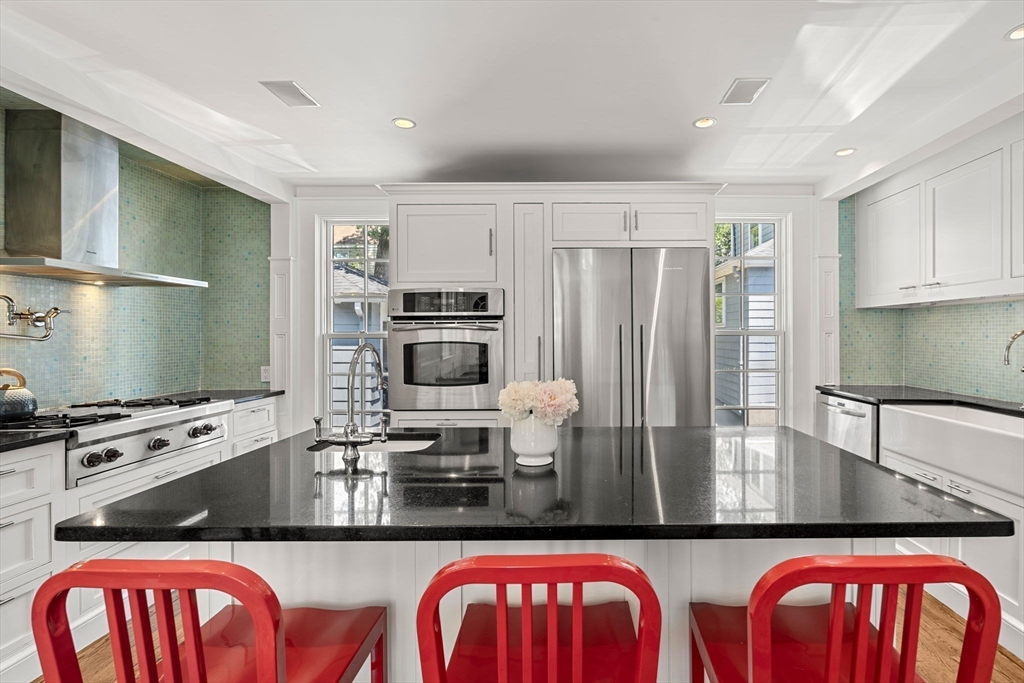 56 Allen Circle Milton, MA 02186 - Photo 5 of 34 a kitchen with stainless steel appliances granite countertop a stove a sink and a microwave