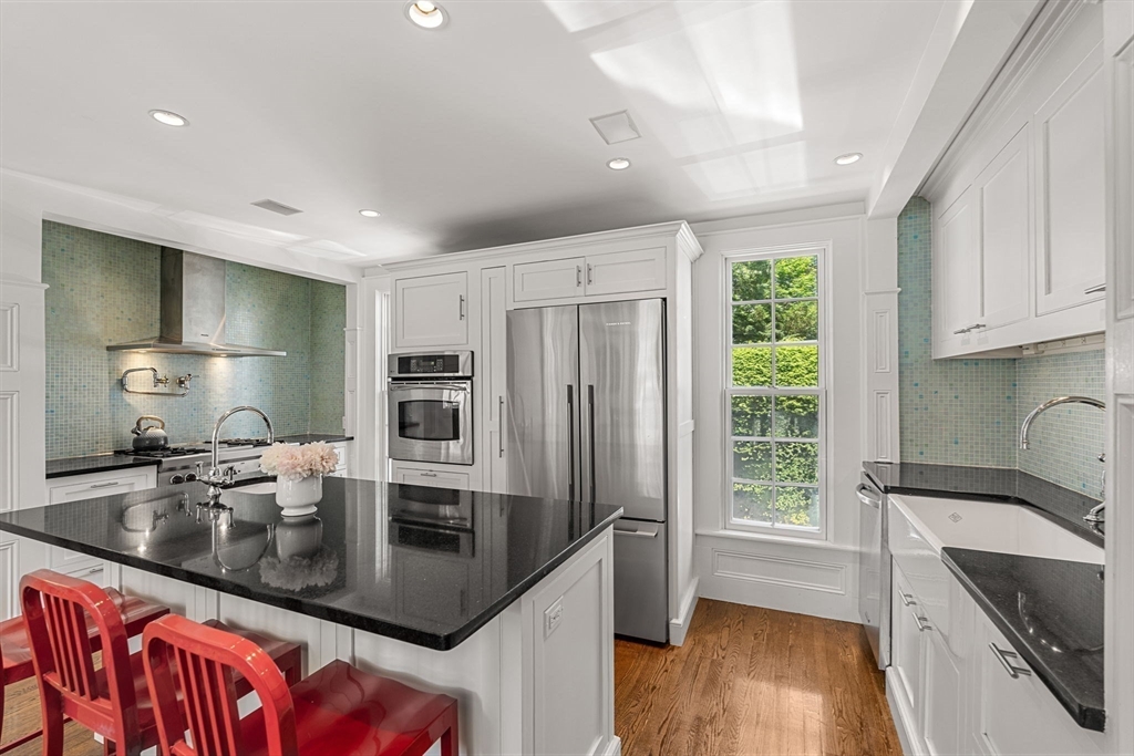 56 Allen Circle Milton, MA 02186 - Photo 6 of 34 a kitchen with stainless steel appliances granite countertop a sink a stove and a refrigerator