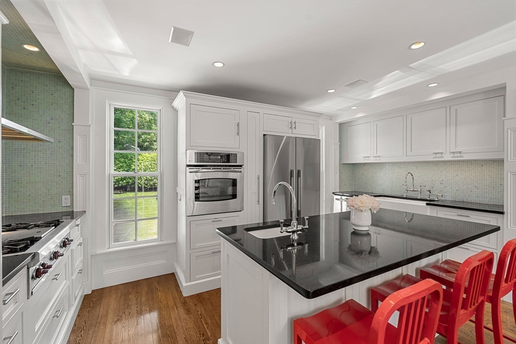 56 Allen Circle Milton, MA 02186 - Photo 7 of 34 a kitchen with kitchen island a sink stove and refrigerator