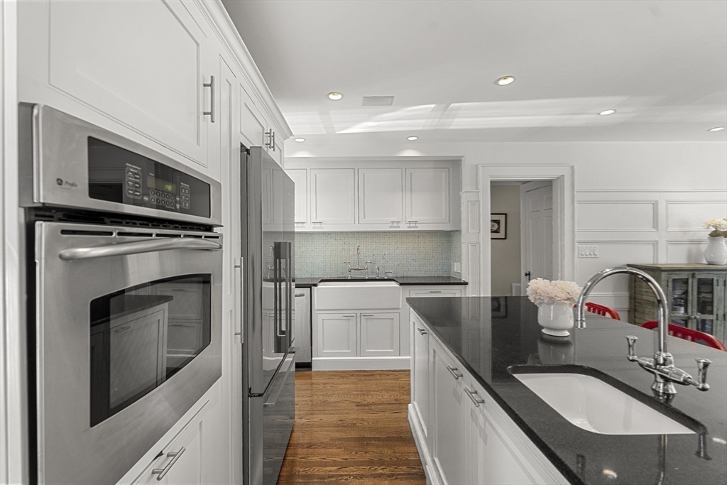 56 Allen Circle Milton, MA 02186 - Photo 9 of 34 a kitchen with a sink stove and microwave